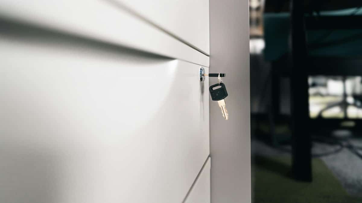 Close-up of a key in a locked office drawer for secure storage and privacy.