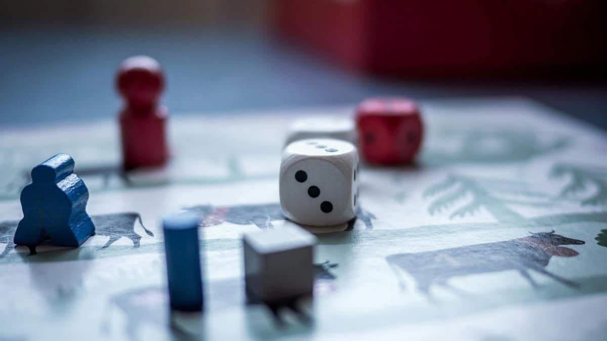 Close-up view of board game pieces and dice on a game board. Perfect for recreation and strategy themes.
