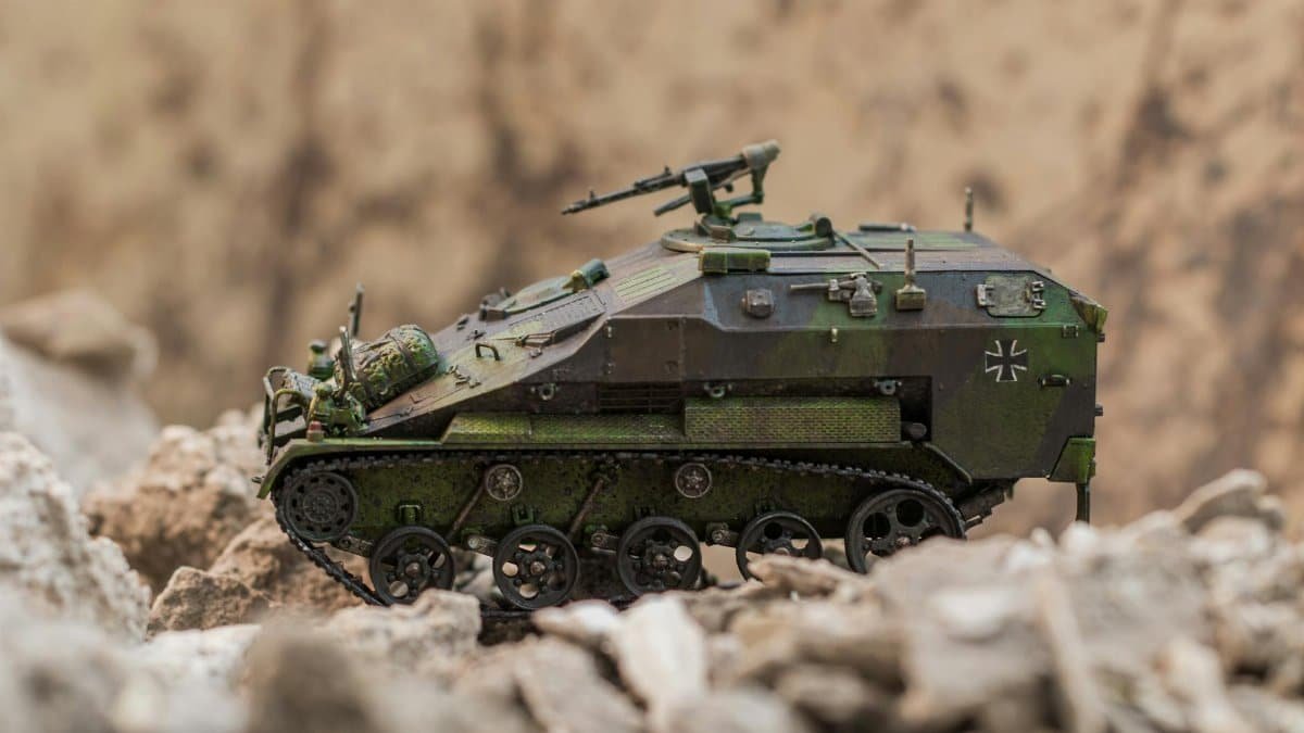 Detailed scale model of a German armored vehicle in a desert-like setting.