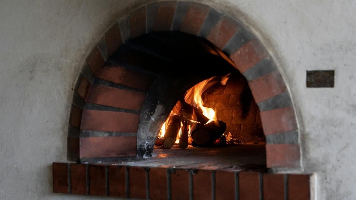 Warm and inviting image of a fireplace with burning logs, perfect for cozy indoor settings.