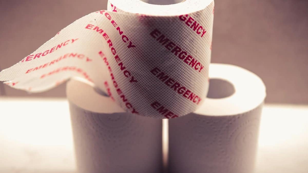 Close-up of toilet paper rolls with 'Emergency' printed, highlighting hygiene essentials.