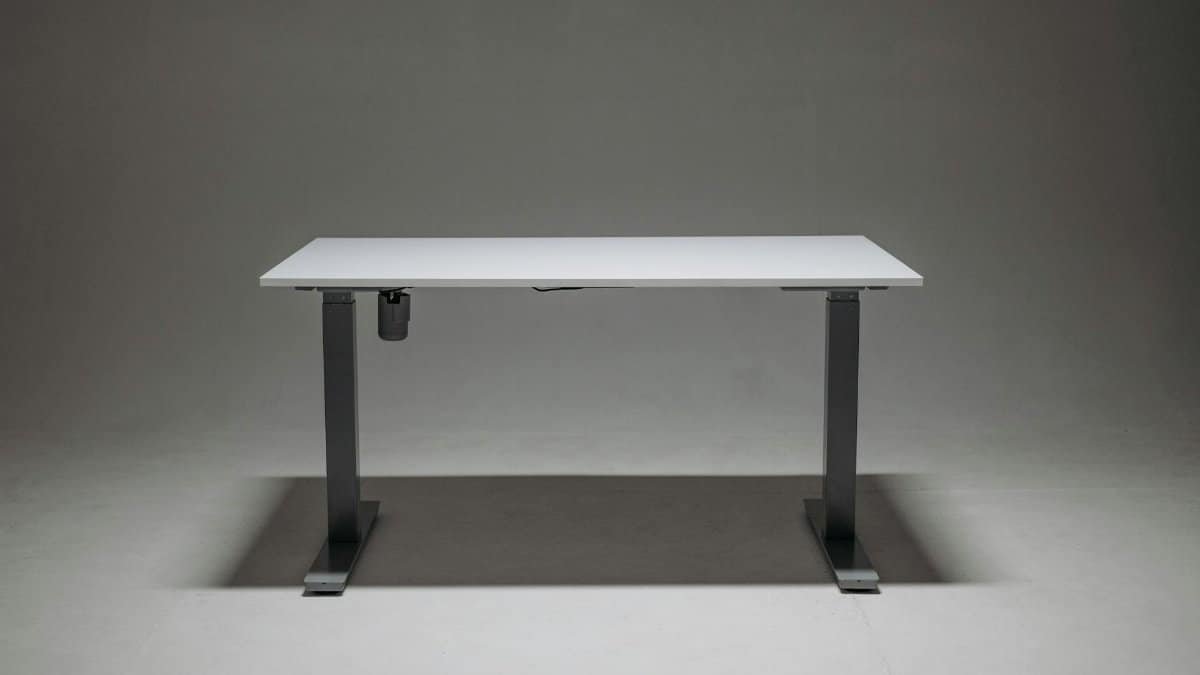 Sleek adjustable height standing desk with a single motor for ergonomic office solutions.