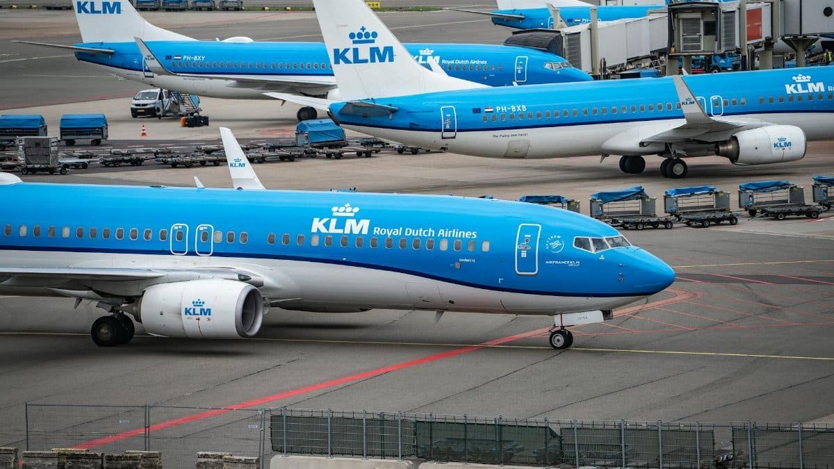 Multiple KLM airplanes parked at Schiphol Airport, ready for departure.