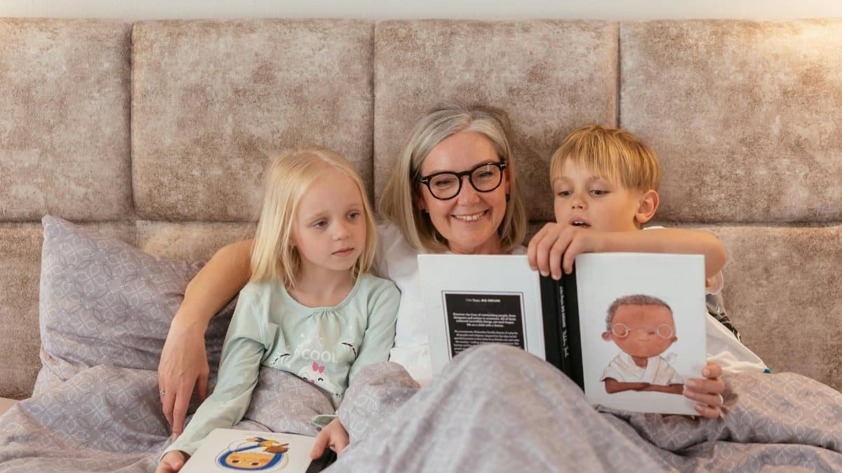 A grandmother reads bedtime stories to her two grandchildren, creating a warm family bond.