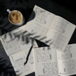 A calming flat lay of a Sudoku puzzle book with coffee, ideal for relaxation and focus.