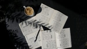 A calming flat lay of a Sudoku puzzle book with coffee, ideal for relaxation and focus.