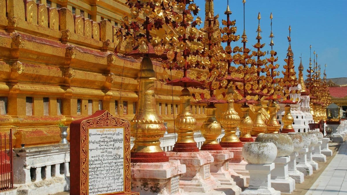 Stunning view of a golden pagoda decorated with ornate spires, showcasing cultural heritage.