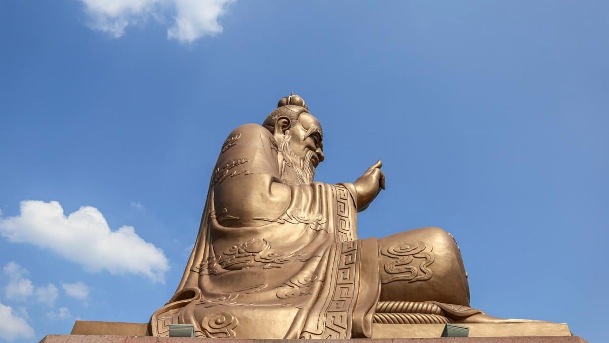 Laozi statue at Yuanxuan Taoist Temple with a clear blue sky backdrop.