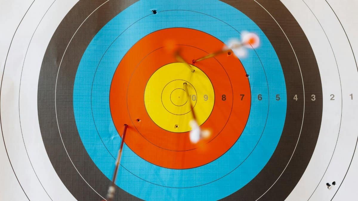 Close-up of a colorful archery target with perfectly hit arrows showcasing precision.