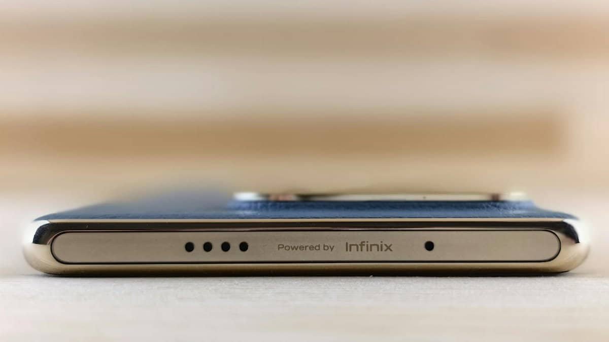 Close-up view of the sleek edge of a smartphone featuring Infinix branding and design.
