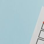 A checklist with a red checkmark symbolizing a completed task on a pastel blue background.