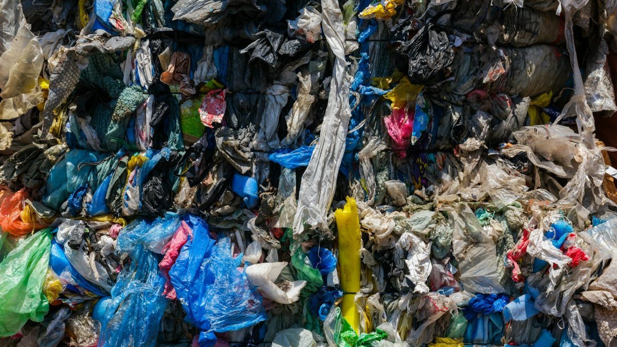 Close-up of compacted plastic waste ready for recycling, highlighting environmental issues.