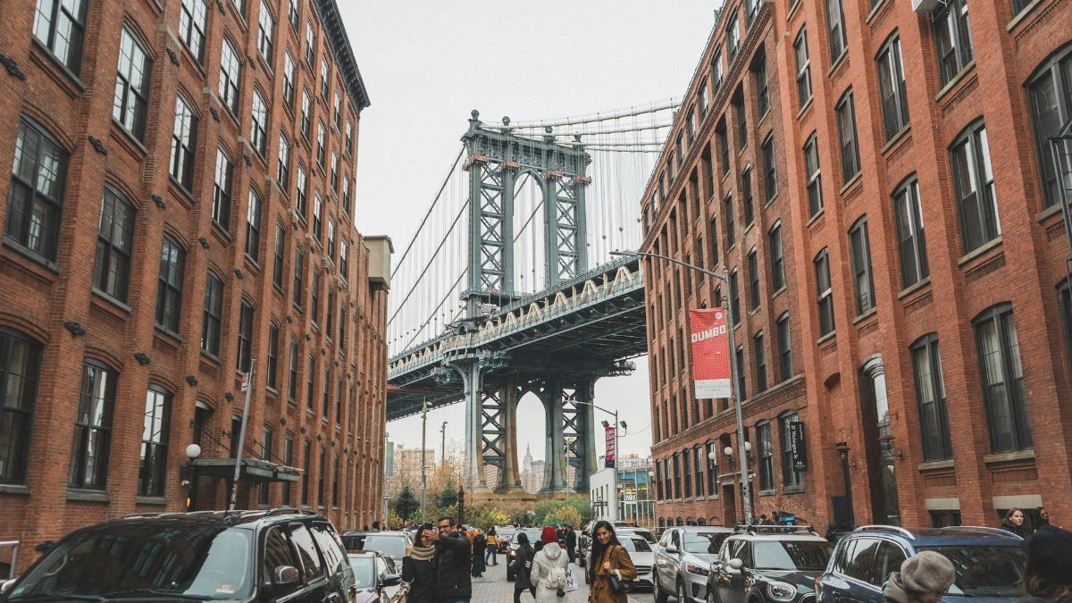 Scenic view of the Manhattan Bridge framed by urban architecture in DUMBO, Brooklyn, NYC.