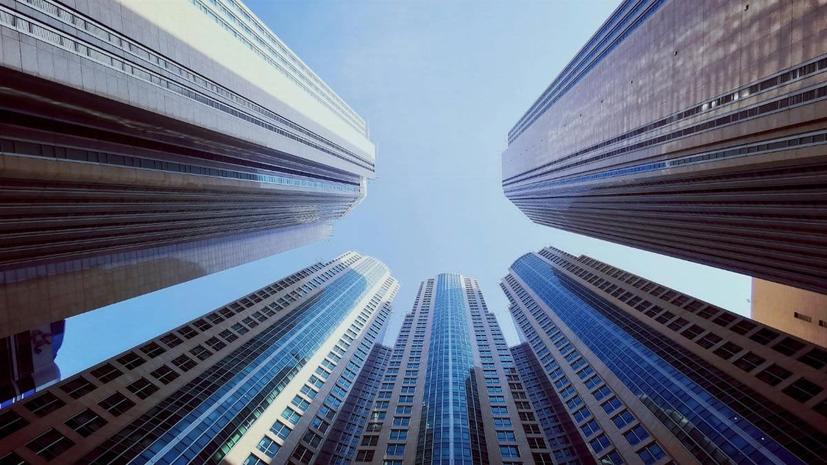 Impressive low angle view of towering high-rise buildings against a clear sky in Abu Dhabi.