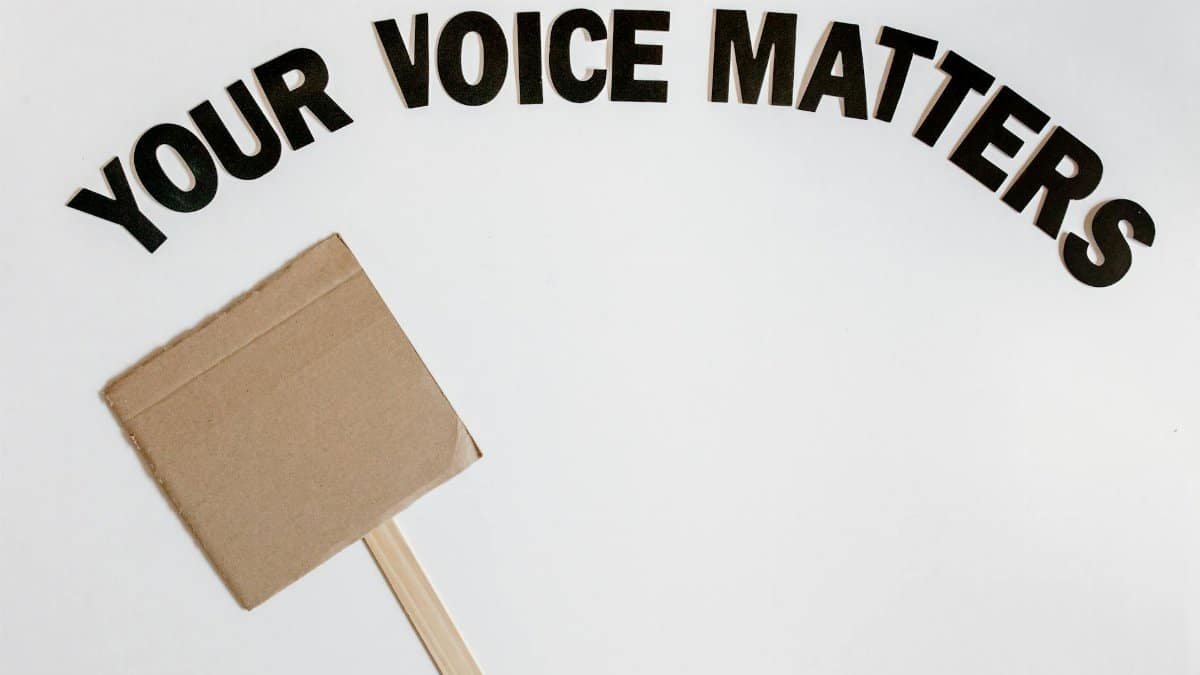 Cardboard protest sign with text 'Your Voice Matters' emphasizes empowerment and advocacy.