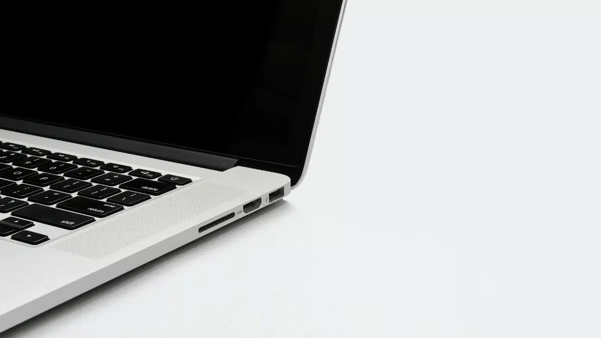 Closeup of a sleek laptop keyboard and screen on a white background. Perfect for tech-related content.