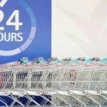 Row of shopping trolleys outside a 24-hour supermarket in Singapore, emphasizing convenience and accessibility.