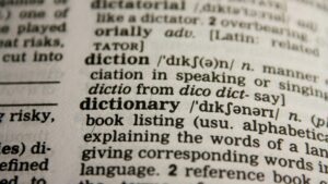 Detailed close-up view of a dictionary page highlighting the word 'dictionary' and its definition.