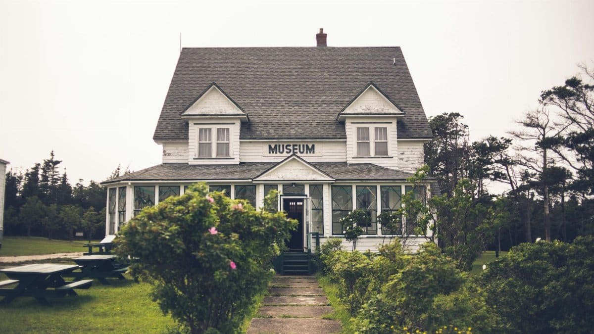 A quaint museum nestled in the countryside surrounded by lush greenery.