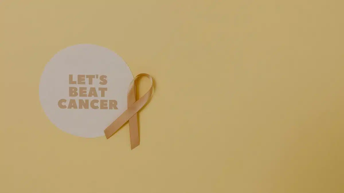 Minimalist design featuring a ribbon and 'Let's Beat Cancer' message for cancer awareness.