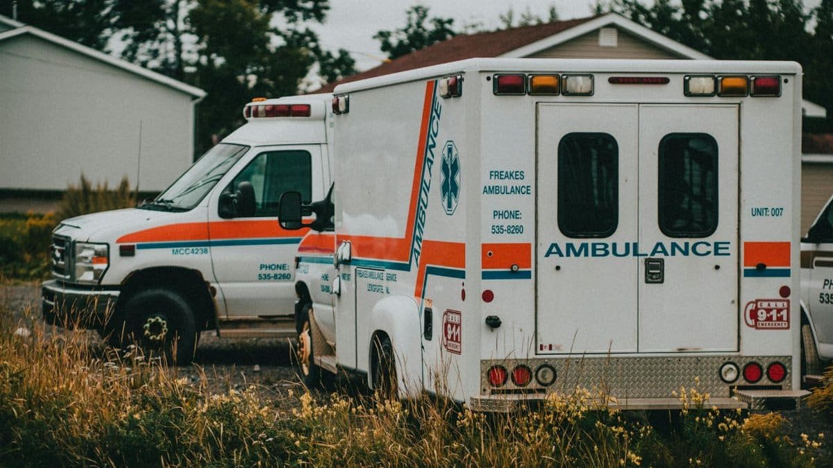 Two ambulances parked in a rural setting, ready for emergencies.