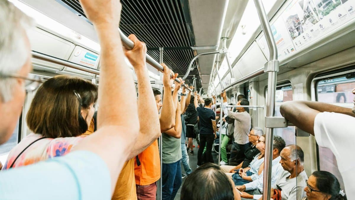 Commuters packed in a metro train, capturing the hustle of urban public transport.