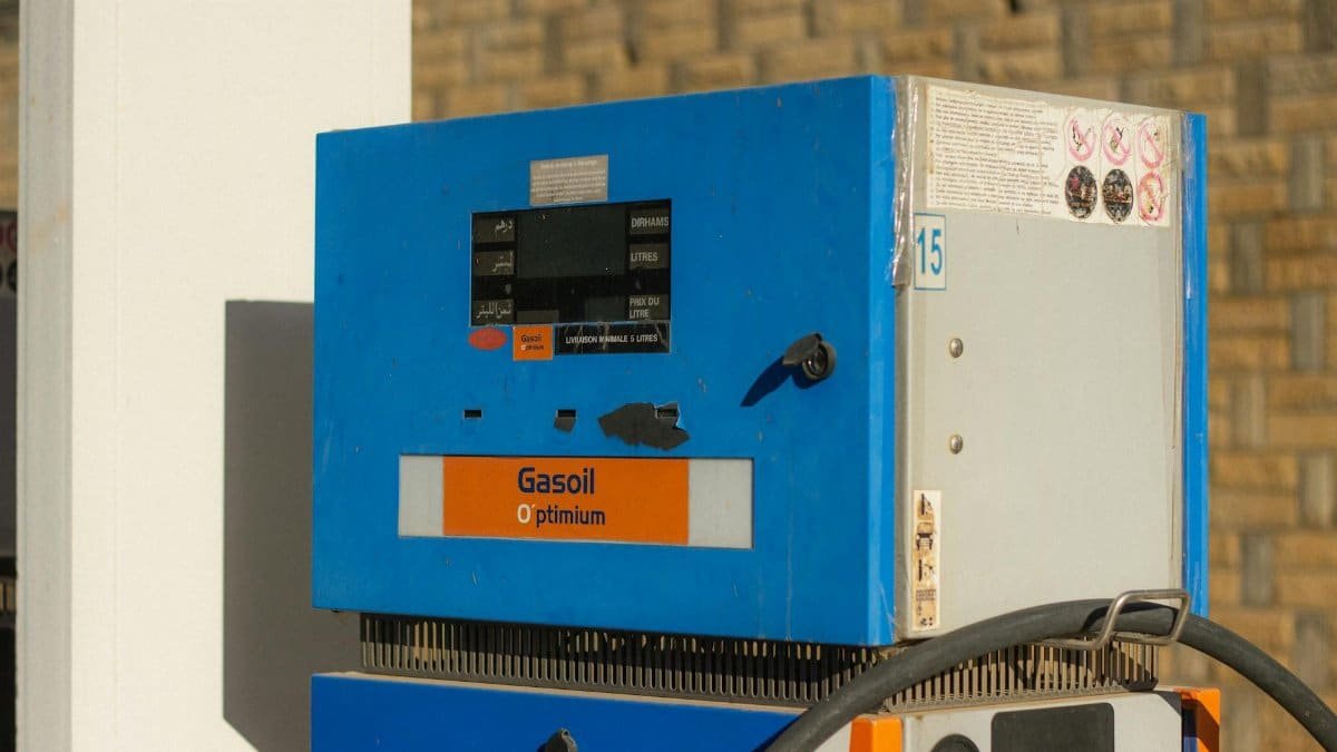 Close-up of a vintage gasoline pump with 'Gasoil Optimum' label in blue and orange.