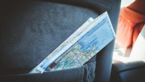 A folded map in a car seat pocket, perfect for planning a road trip.
