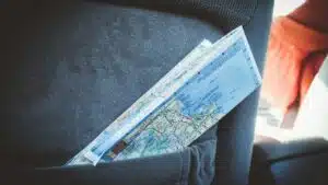 A folded map in a car seat pocket, perfect for planning a road trip.