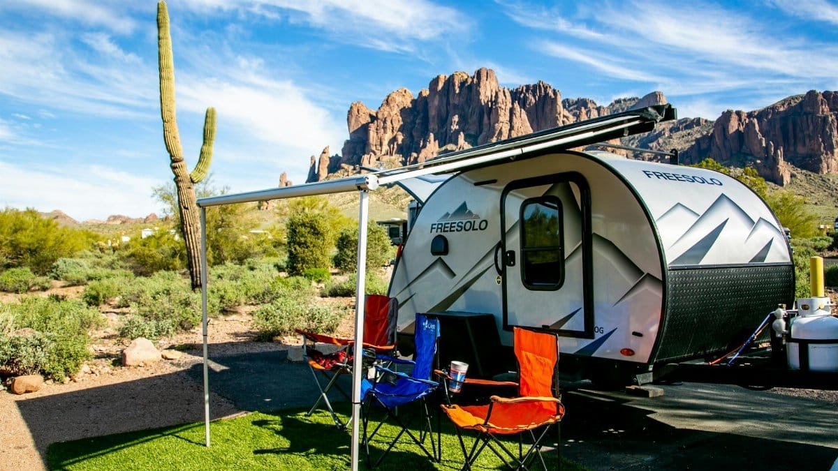 Explore breathtaking camping views at Apache Junction with a camper and iconic cactus backdrop.