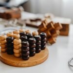 Close-up of various wooden brain teaser puzzles arranged on a table indoors.
