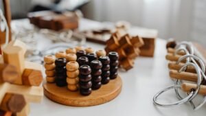 Close-up of various wooden brain teaser puzzles arranged on a table indoors.