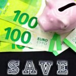 A piggy bank on euro bills with 'save' text highlights money saving concepts.