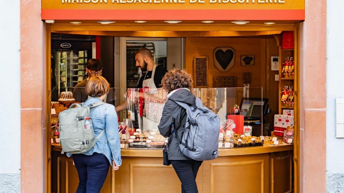 Visitors at Maison Alsacienne de Biscuiterie in Colmar, enjoying local pastries.