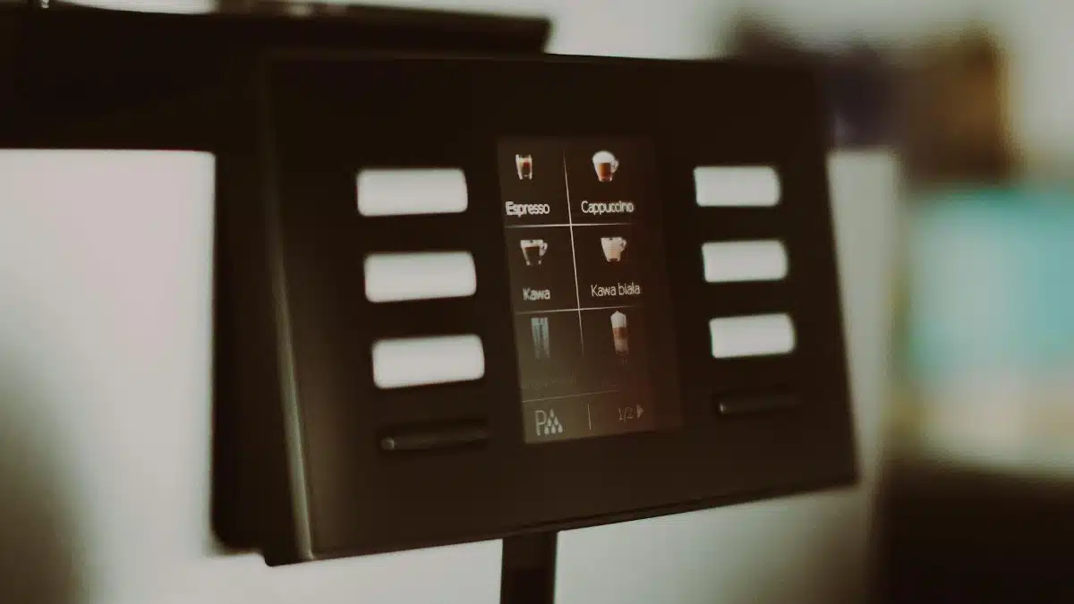 Close-up of a digital coffee machine display showcasing espresso and cappuccino options.