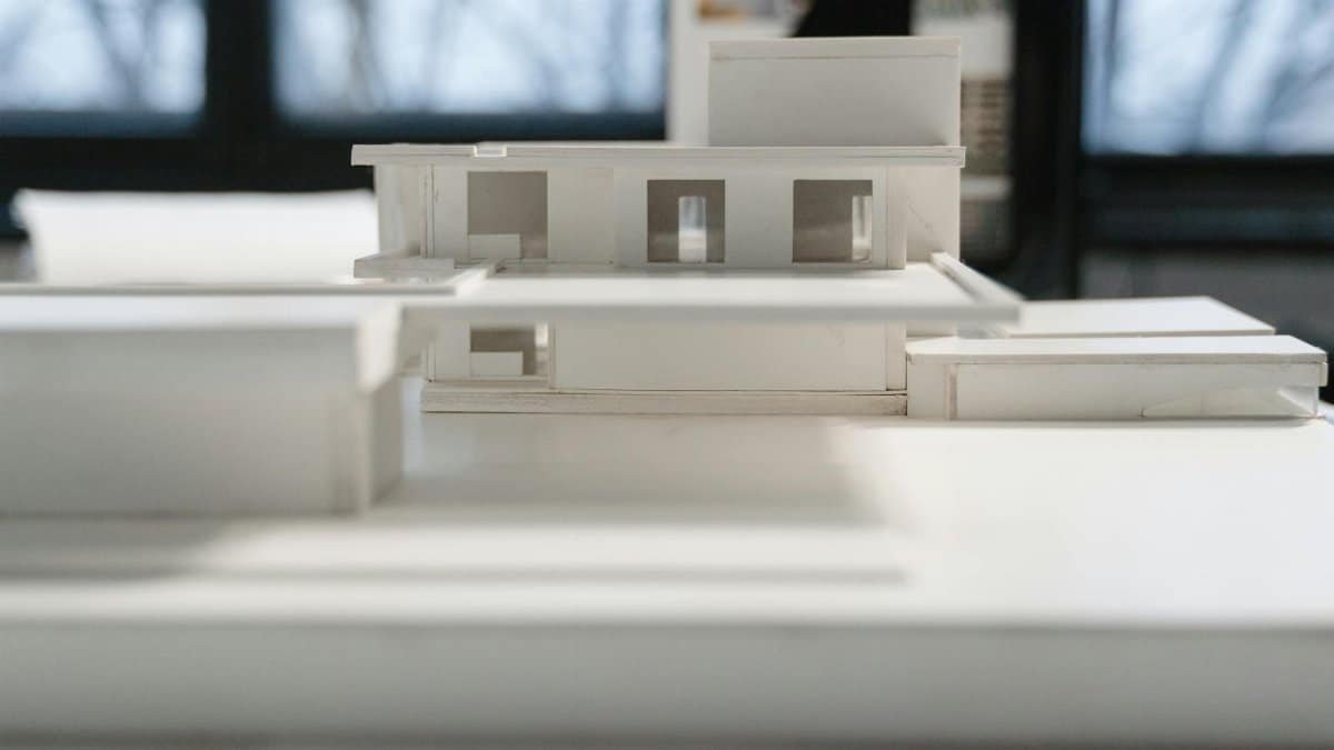 Detailed miniature architectural model indoors with natural light and modern design elements.
