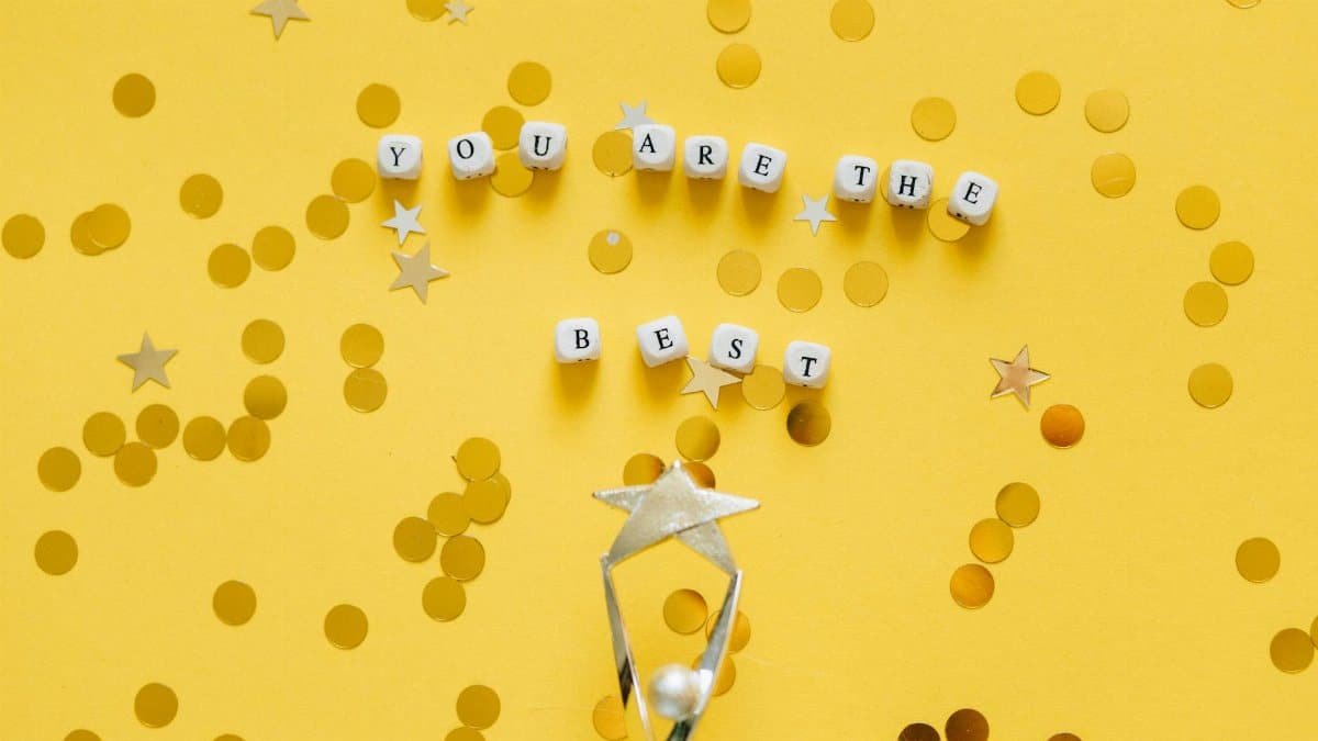 Inspirational layout with 'You Are the Best' message and star confetti on a golden background.