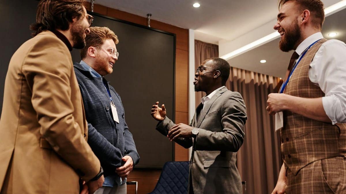 Business colleagues engaged in friendly conversation during a corporate meeting.