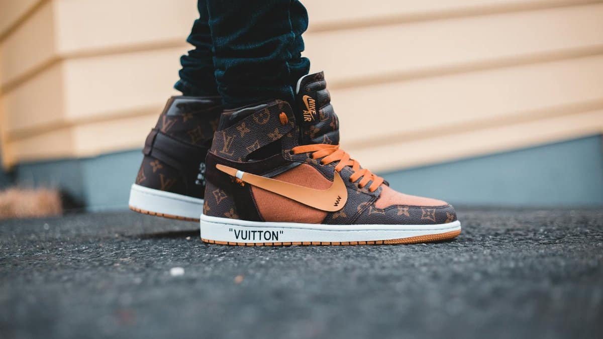 Pair of luxury collaboration sneakers featuring iconic brands, captured outdoors.