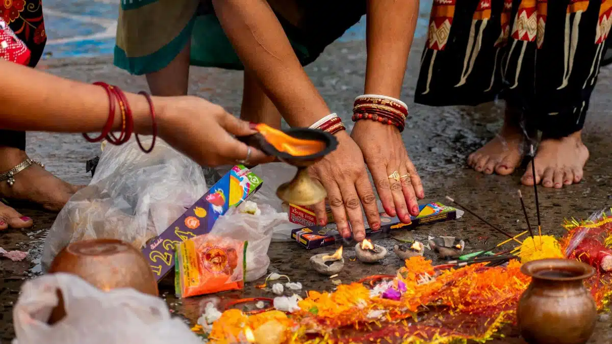 Colorful Hindu ritual ceremony during Ganga Puja in Kolkata, India, highlighting vibrant traditions.