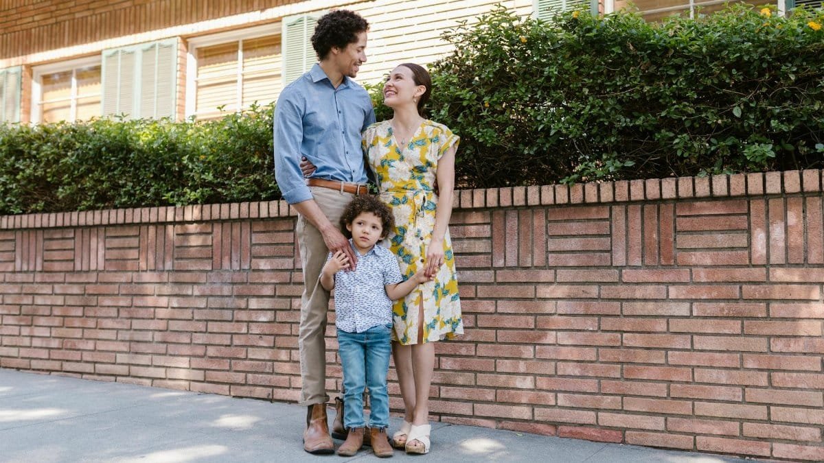 Loving family enjoying a sunny day outdoors, smiling together.