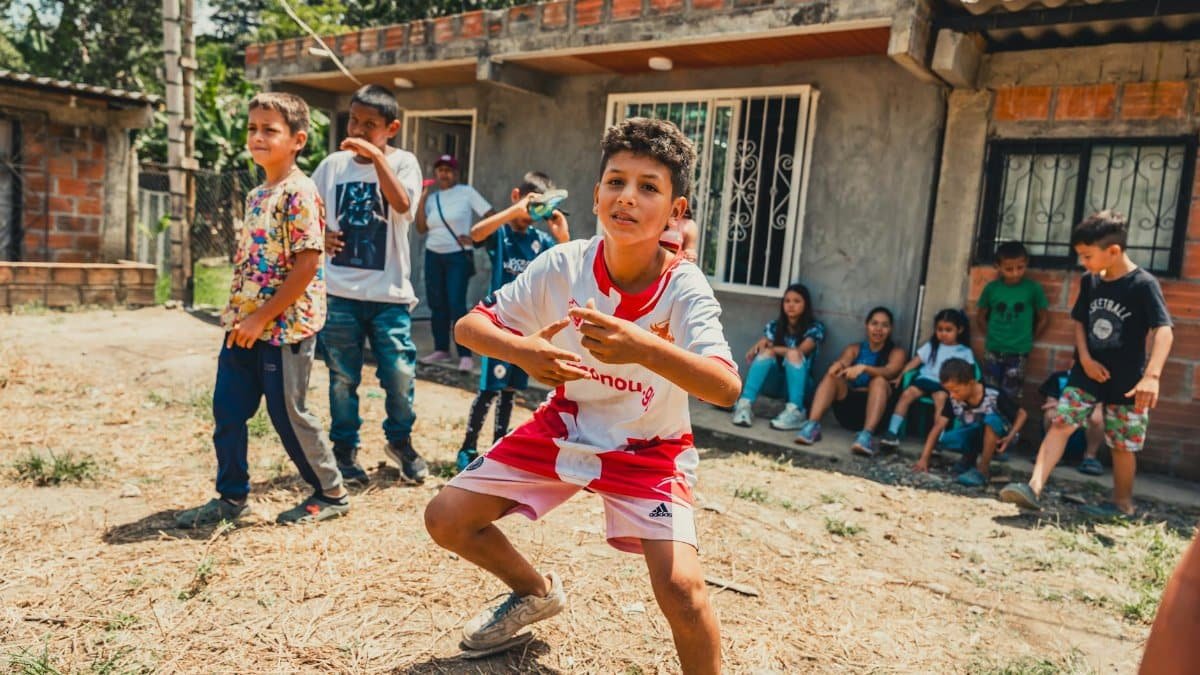 Kids enjoying a playful day outdoors in a rustic neighborhood setting, showcasing community spirit.