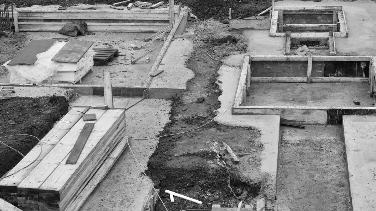 Aerial view of concrete foundations at a construction site, showing early building phases.