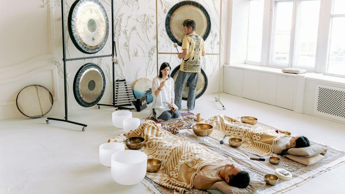 A serene indoor sound bath session with gongs and singing bowls promoting relaxation and wellness.