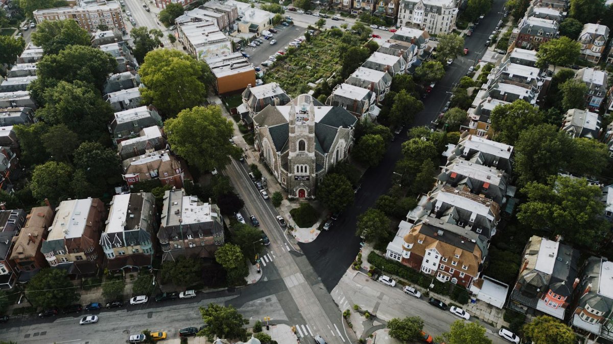 Drone shot capturing a scenic Philadelphia neighborhood with a prominent church at the center.