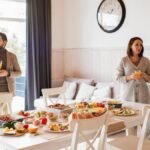 Friends enjoying a cozy brunch indoors with a full spread of delicious food and drinks.