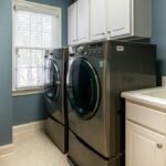 A clean, organized laundry room featuring modern appliances and ample storage.