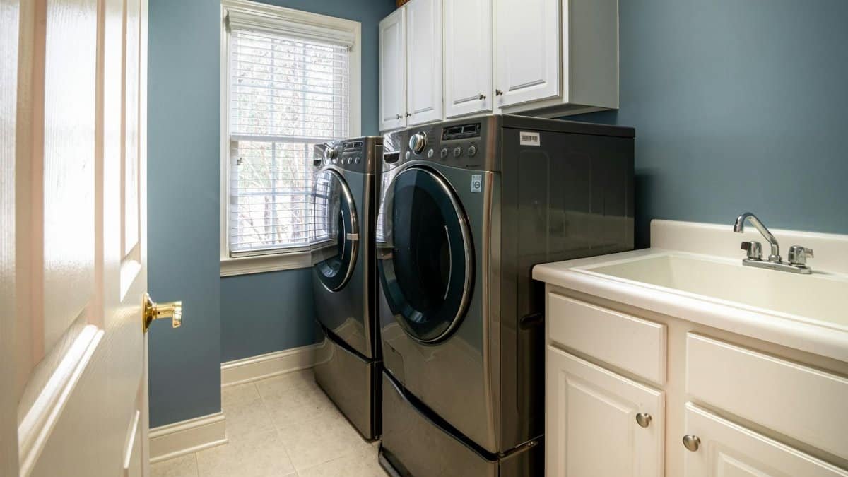 A clean, organized laundry room featuring modern appliances and ample storage.