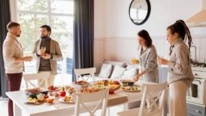 A group of friends enjoying a brunch with various dishes indoors. Warm and casual dining atmosphere.