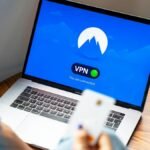 A person using a VPN on a laptop, symbolizing secure internet browsing in a modern indoor setting.